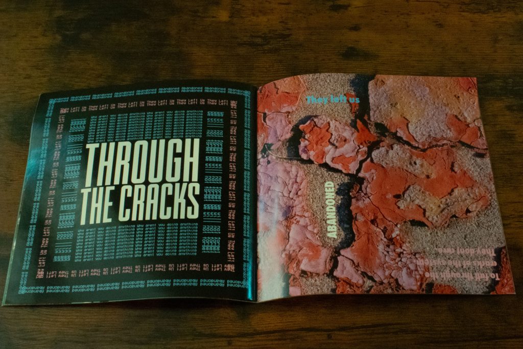 A physical two page spread of the Zine titled Erased
